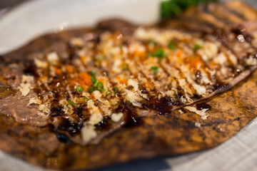 Roasted beef on Oba leaves, Wagyu Beef of Japan, grilled on traditional Japanese oven, Ancient Japanese Cuisine.