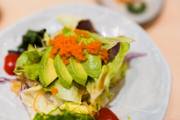 Healthy vegetable diet avocado salad on a plate. Top view