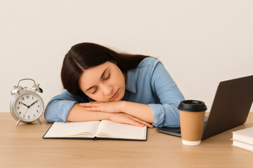 Young woman resting her head on folded arms
