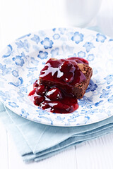 Chocolate brownie with cherry syrup . Selective focus. Copy space.	