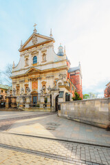 Fototapeta premium Main street Rynek Głowny in Krakow with square and church St. Mary's Basilica in Poland