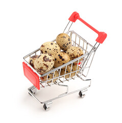 Shopping cart with fresh quail eggs on white background