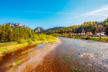 Peak Tri Koruny or Trzy Korony during day with green meadow and trees in spring. Pieniny National park in Slovakia and Poland