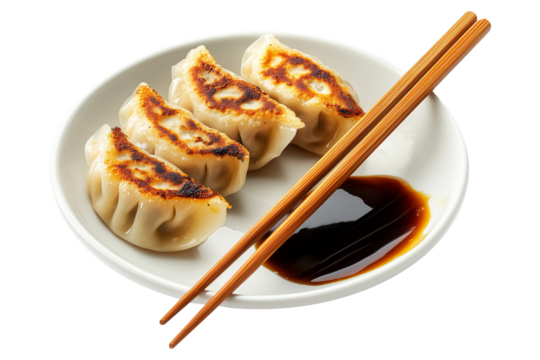 Grilled Japanese gyoza dumplings served on white plate with soy sauce and wooden chopsticks, isolated on white transparent background - Powered by Adobe