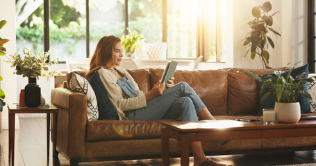 Tablet, relax and woman on sofa in home for reading online blog, newsletter or research on plants....