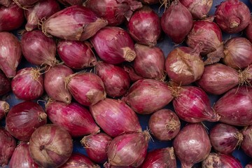 Background of onion heads at the market - natural texture and healthy food concept. Organic...