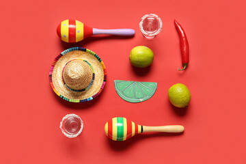 Mexican maracas with sombrero, tequila and limes on red background. Cinco de Mayo