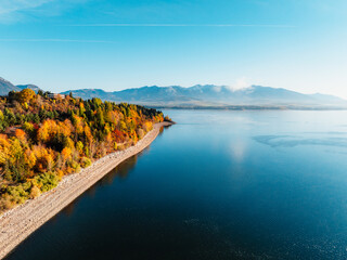 Liptov region with Tatras mountains around. Liptovska mara dam landspace. Autumn deciduous forest...
