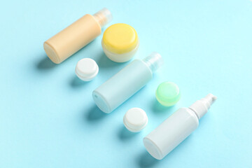 Composition with travel cosmetic bottles and jars on color background