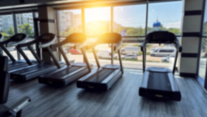 Blurred fitness gym equipment for sport banner background.Fitness center blur background.