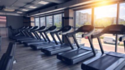 Blurred fitness gym equipment for sport banner background.Fitness center blur background.