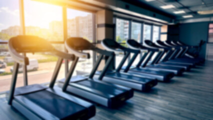 Blurred fitness gym equipment for sport banner background.Fitness center blur background.