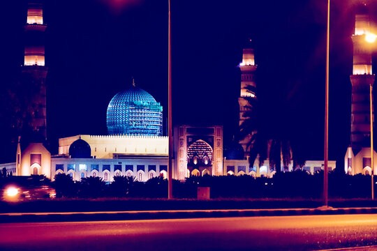Night Oman with illuminated minarets and a mosque