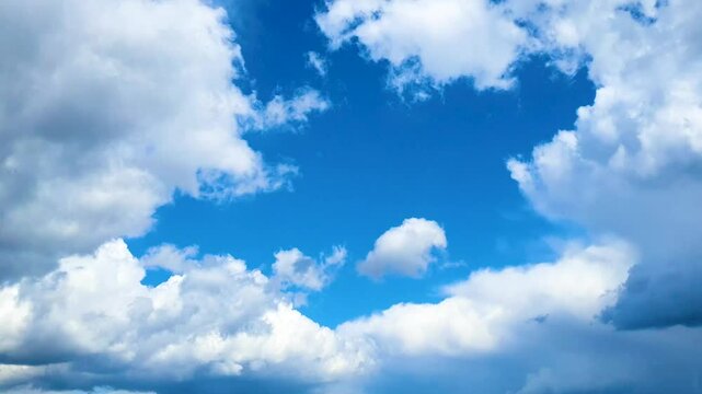 Beautiful sky with dramatic in captivating time-lapse video. Fluffy white clouds as a background for relaxation videos or a transition element in films and commercials. Drastic weather change.