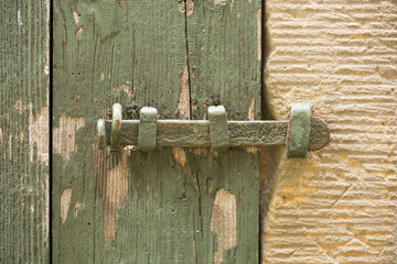 Green Locked Wooden Gate in a Natural Stone Wall