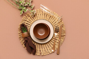 Beautiful table setting with gypsophila flowers and leaves on brown background
