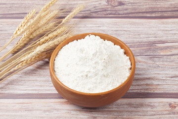 Flour is a powder made by grinding wheat.
