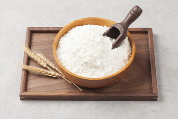 Flour is a powder made by grinding wheat.
