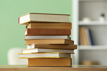 Stack of books on coffee table in living room, closeup