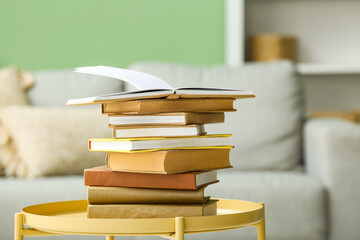 Stack of books on coffee table in living room, closeup