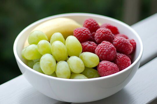 Fresh fruit bowl filled with nutritious grapes and raspberries - Powered by Adobe