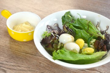 boiled quail egg with vegetable salad on plate dressing mayonnaise cream sauce