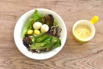 boiled quail egg with vegetable salad on plate dressing mayonnaise cream sauce