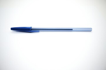 One blue pen with white background.
