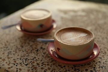 Aromatic coffee served on light table, closeup