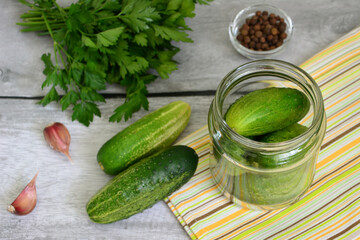 Fresh Cucumbers and Pickling Ingredients in a Glass Jar