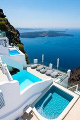 White architecture in Santorini island, Greece. Luxury swimming pool with sea view