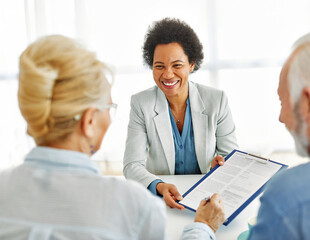 Senior couple having a meeting with an agent, businesswoman, salesperson or doctor  in his office