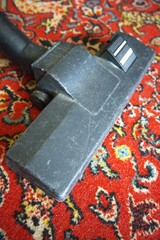 The big cleaning close up. Vacuum cleaner on tha mat.
