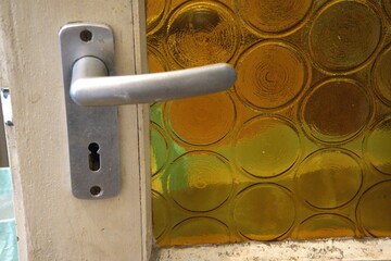 Retro style door with yellow glass and old handle.