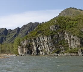 Majestic Mountain Landscape with River, Rocks, and Lush Greenery, Perfect for Outdoor Adventures