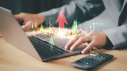 Business, finance and investment concept. Businessman using computer laptop analyzing and...