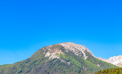 Alpine mountain and hill landscape panorama blue sky Tyrol Austria.