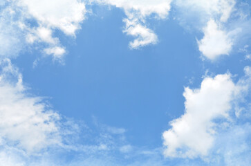 Bright blue sky background with white border of fluffy clouds .Nature, beautiful sky landscape in sunny weather.