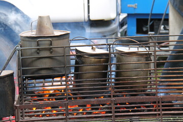 Large Food Cooking Pots on an Open Air Coal Fire.