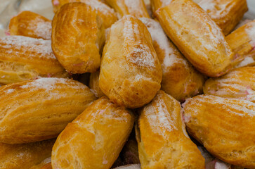 freshly baked eclairs with powdered sugar