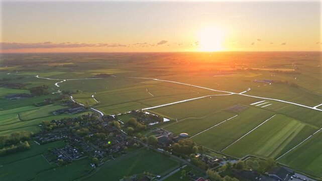 Aerial view of Dutch polder farmland and canals at sunset