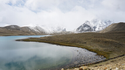 Mountain landscape with lake and snow in Gurudongmar Lake, Sikkim, India