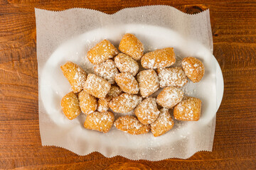 fried dough with powdered sugar