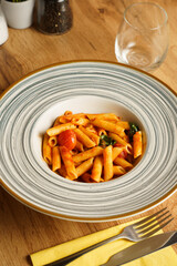 Penne pasta with cherry tomato and basil sauce