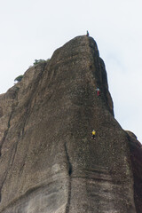 Tourist climbing on rope up at the Meteora rock formations, Kalambaka, Thessaly, Greece