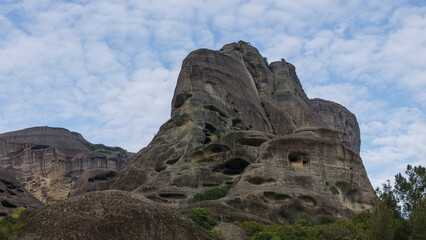 Caves in side of sandstone rock formations of Meteora once inhabited by hermit monks, Kalambaka, Thessaly, Greece