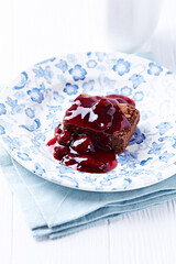 Chocolate brownie with cherry syrup . Selective focus. Copy space.	