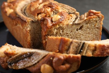 Cut banana bread with nuts on table, closeup