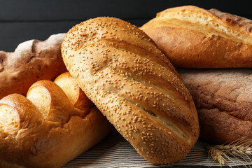 Many different loaves of bread on table, closeup