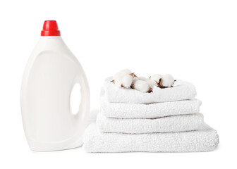 Bottle of fabric softener, stacked towels and cotton flowers isolated on white